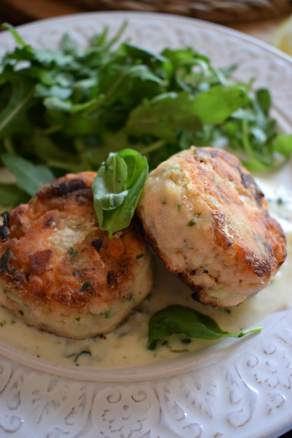 salmon and leek cakes on a plate with salad
