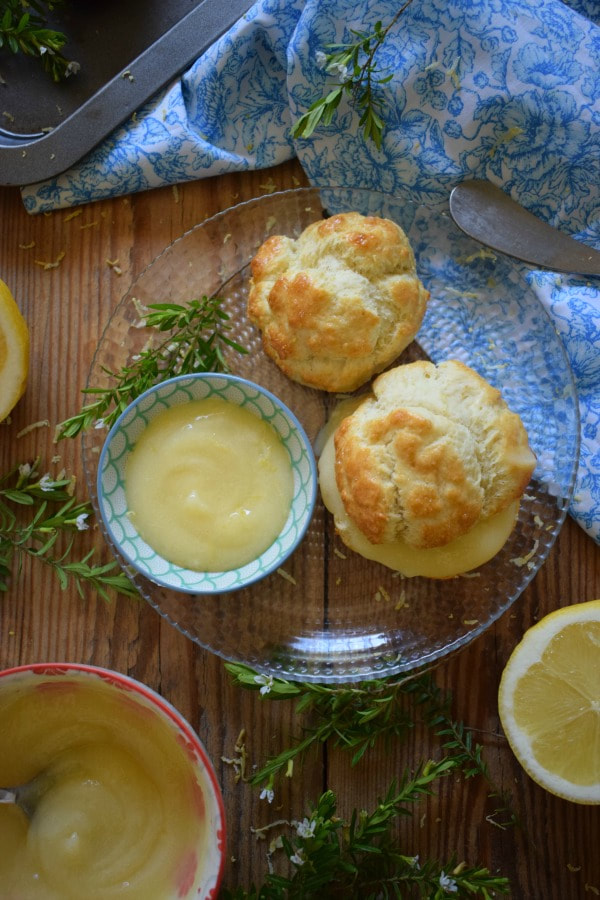 lemon curd filled scones on a plate with lemons