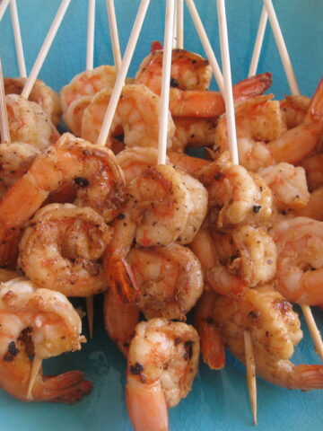 shrimp kebabs on a blue plate