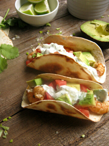 Shrimp tacos on a woodentable.