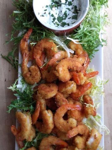 over head view of teh spicy fried shrimp with a minted yogurt dip