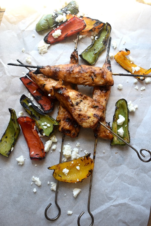 over head view of the teriyaki chicker skewers with a charred pepper salad