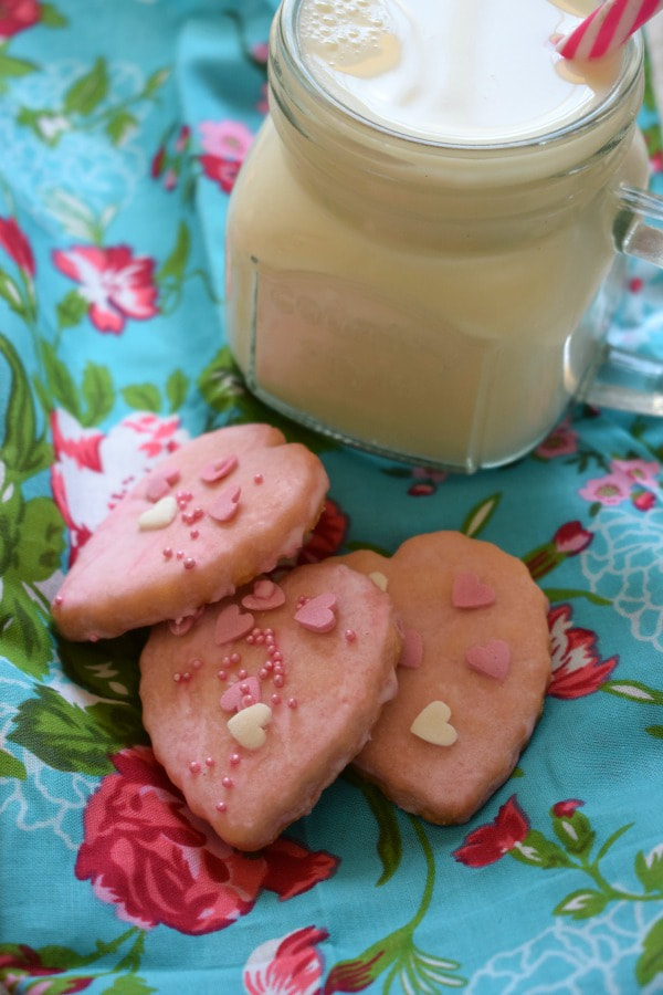 very pink sweetheart cookies with a glass of milk