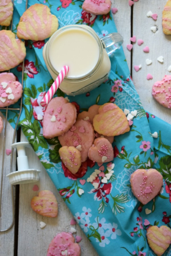 sweetheart cookies with sprinkles and a glass of milk
