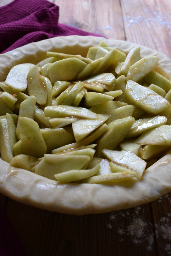 Pie shell filled with apples