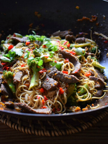 Beef and broccoli noodle stir fry in a wok