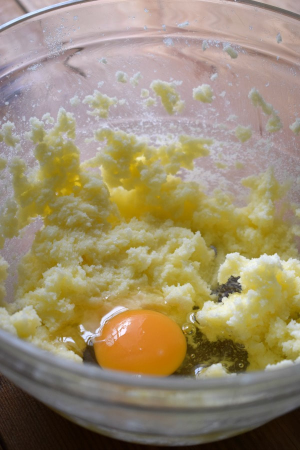 Adding eggs to muffin batter.
