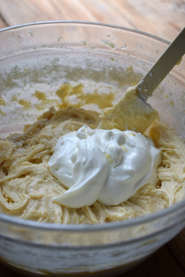 Adding yogurt to muffin batter.