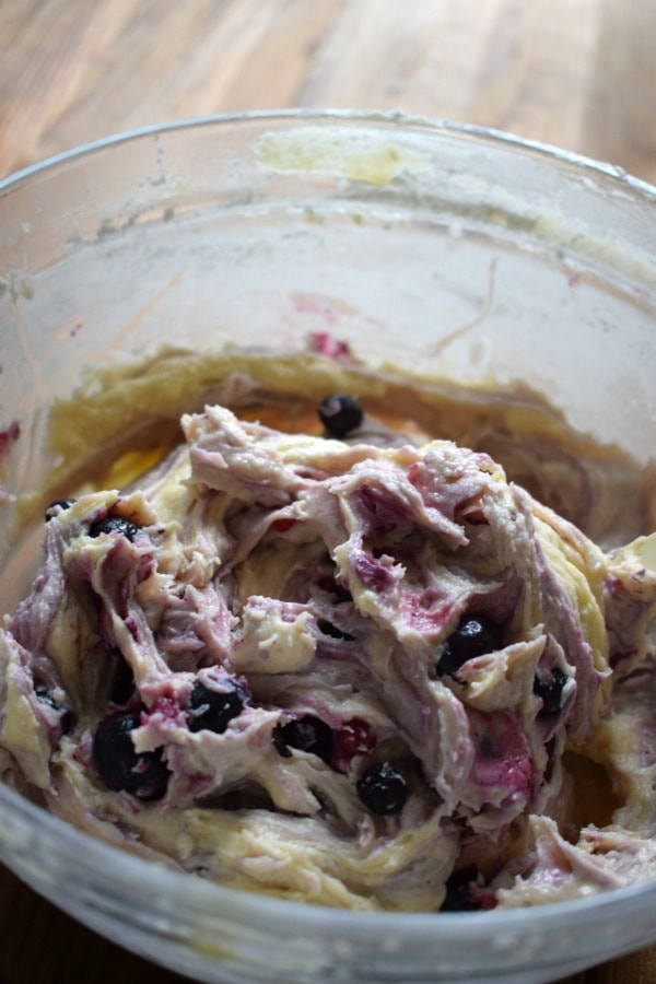 Mixed berry muffin batter in a glass bowl.