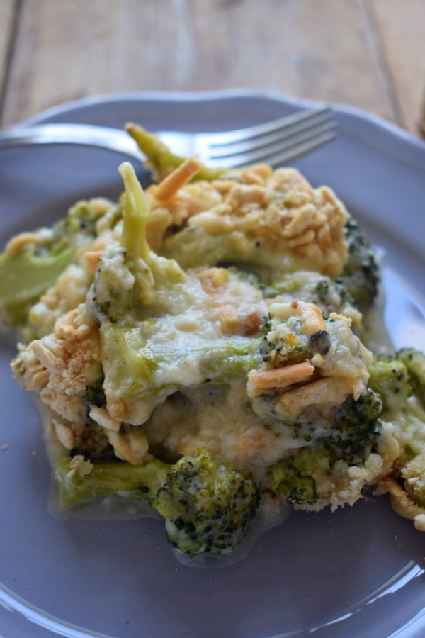 broccoli and cheddar casserole on a grey plate