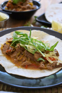 Mexican carnitas topped with lettuce and cheese.