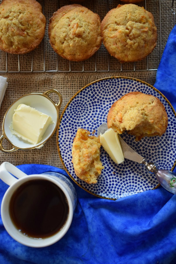 over head view of the buttery carrot muffins with a cup of tea