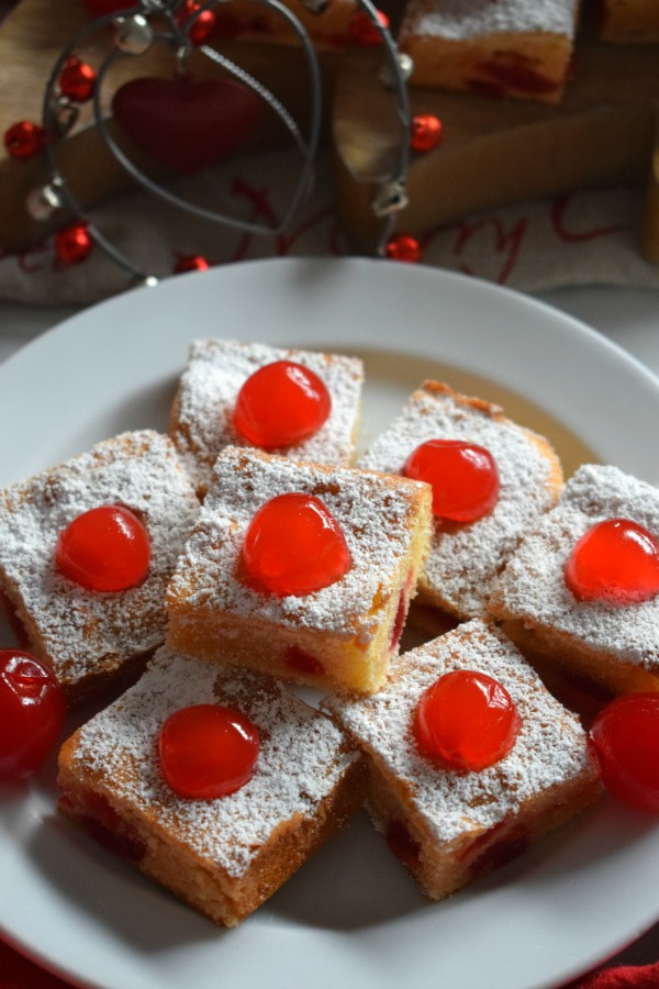 Cherry Cake squares on a white plate