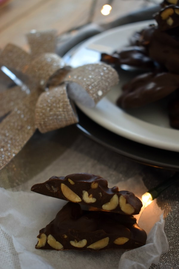 cluse up of a chocolate peanut cluster with christmas decorations
