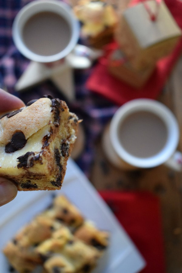 Close up view of the Cream Cheese Chocolate Chip Squares with mugs below