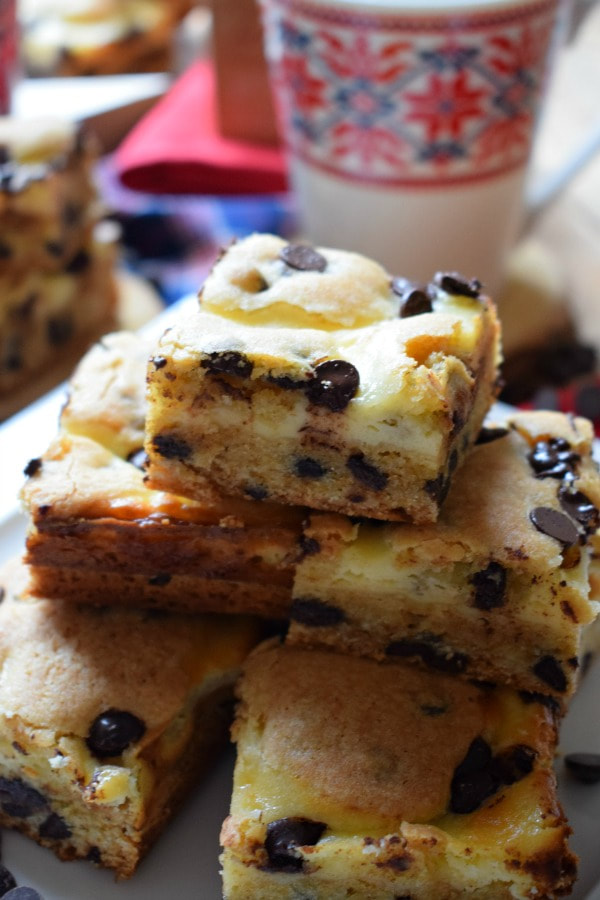 Close up view of the Cream Cheese Chocolate Chip Squares and a mug in the background