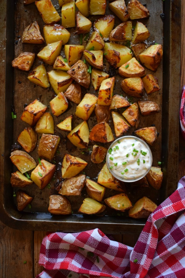 crispy potatoes on a baking tray with dip
