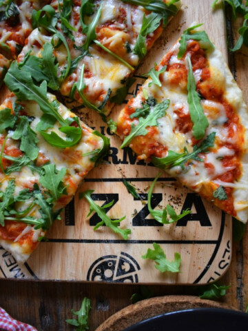 Grilled Arugula & Basil Pizza on a pizza board