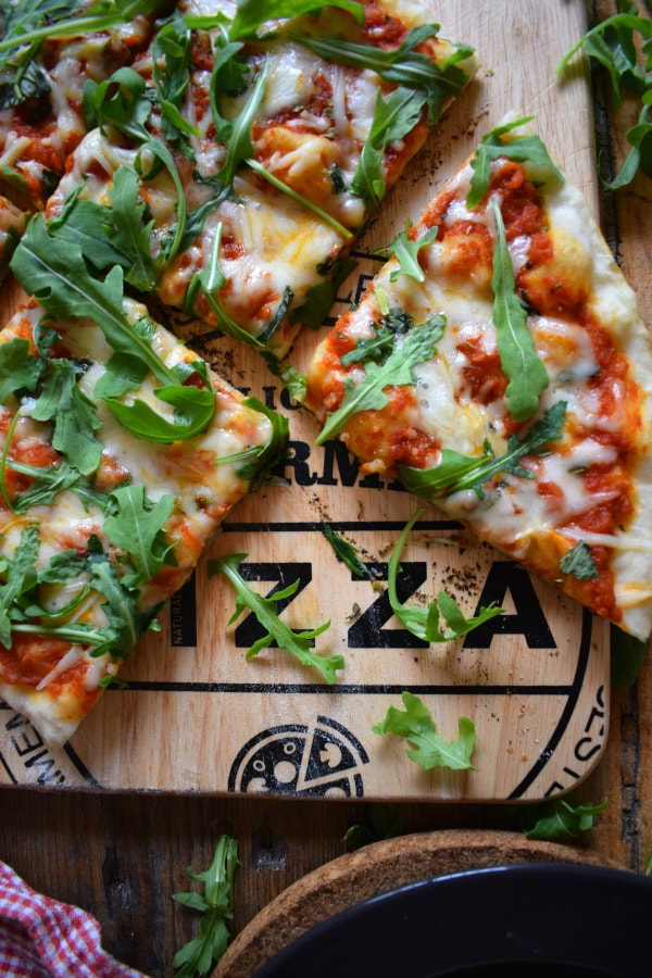 Grilled Arugula & Basil Pizza on a pizza board