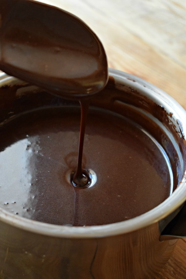 Cooked chocolate icing in a saucepan.