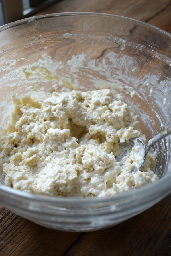 Making pizza dough in a glass bowl.