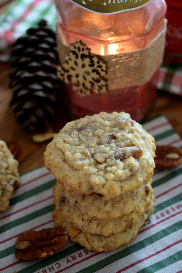 A stack of pecan oatmeal cookies with a candle 
