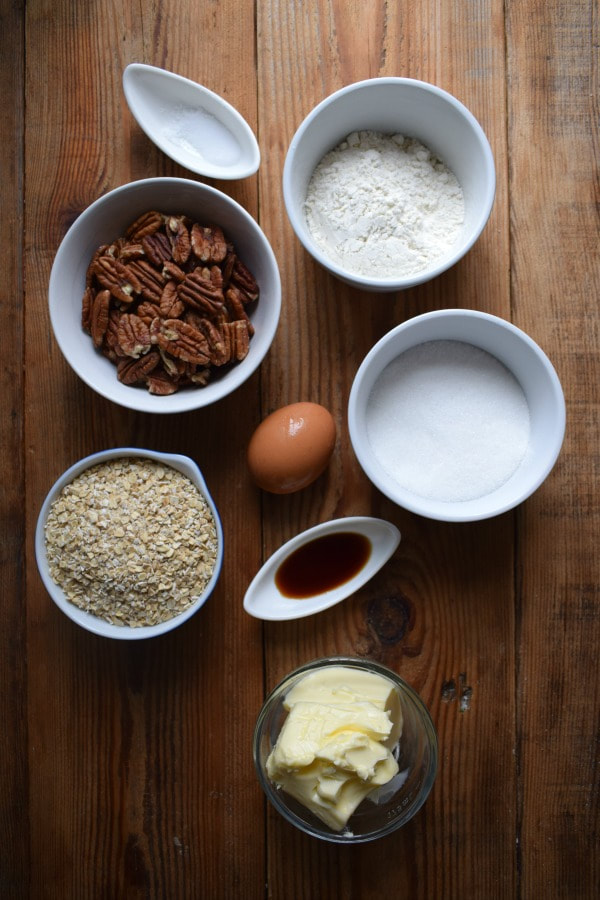 Ingredients on a wooden board for pecan cookies