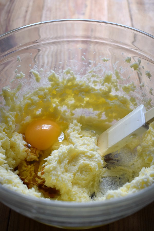 mixing butter and sutar withi eggs to make pecan cookies