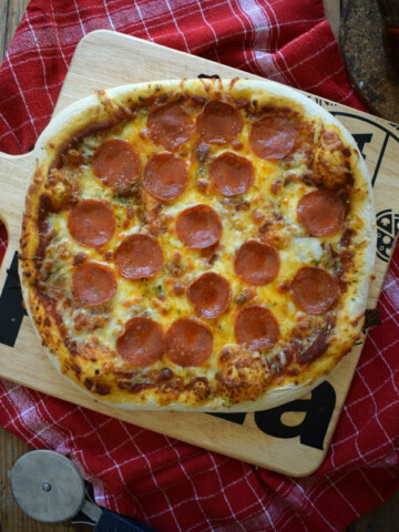 Pepperoni pizza on a pizza board