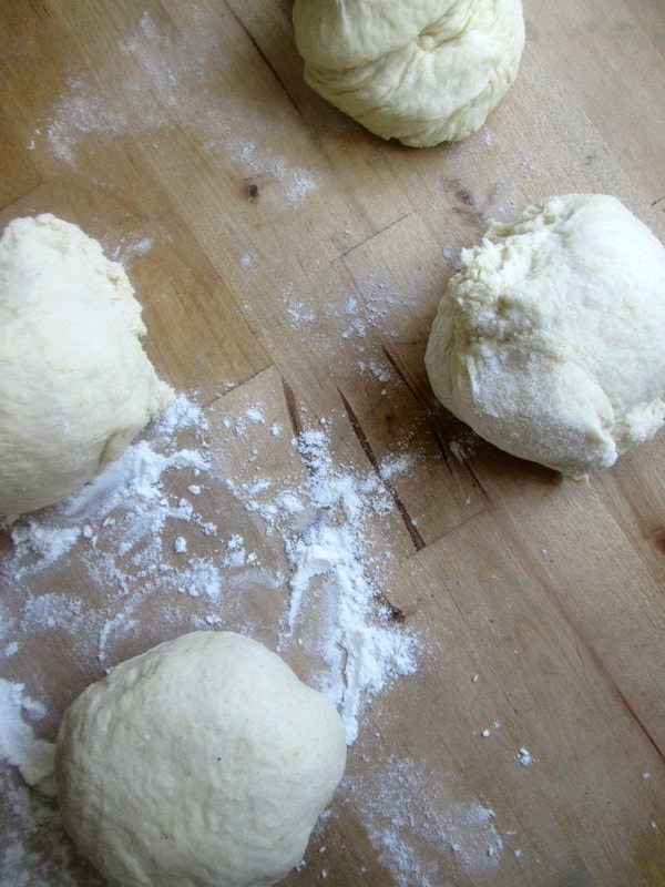 pizza dough divided into four dough balls