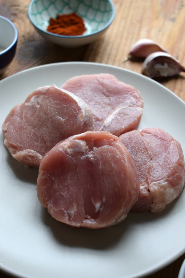 uncooked pork medallions on a plate