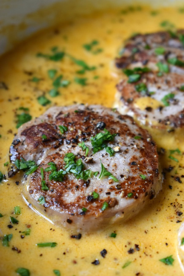 pork medallions in a sauce on the stovetop