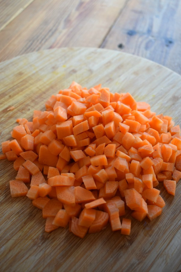 chopped carrots on a cutting board to make carrot soup