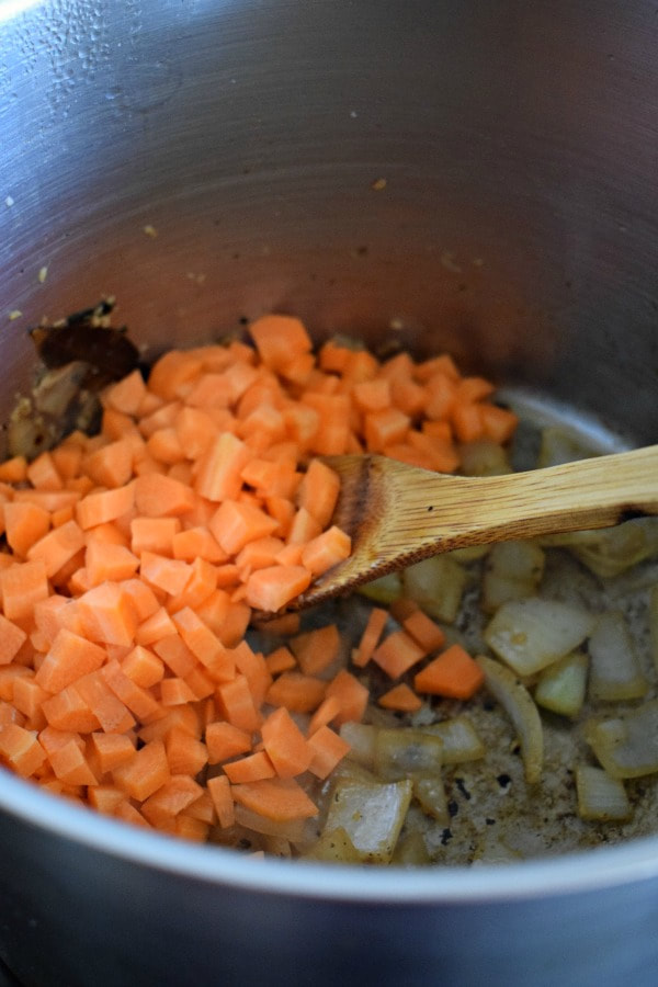 chopped carrots in a pot to make soup