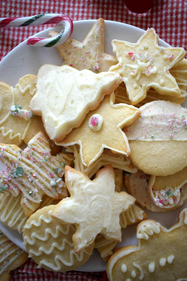 butter cream topped sugar cookies with a candy cane