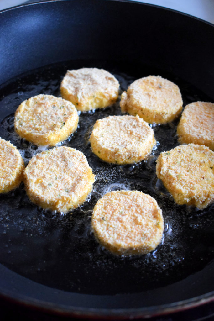 Frying goat cheese in a skillet.