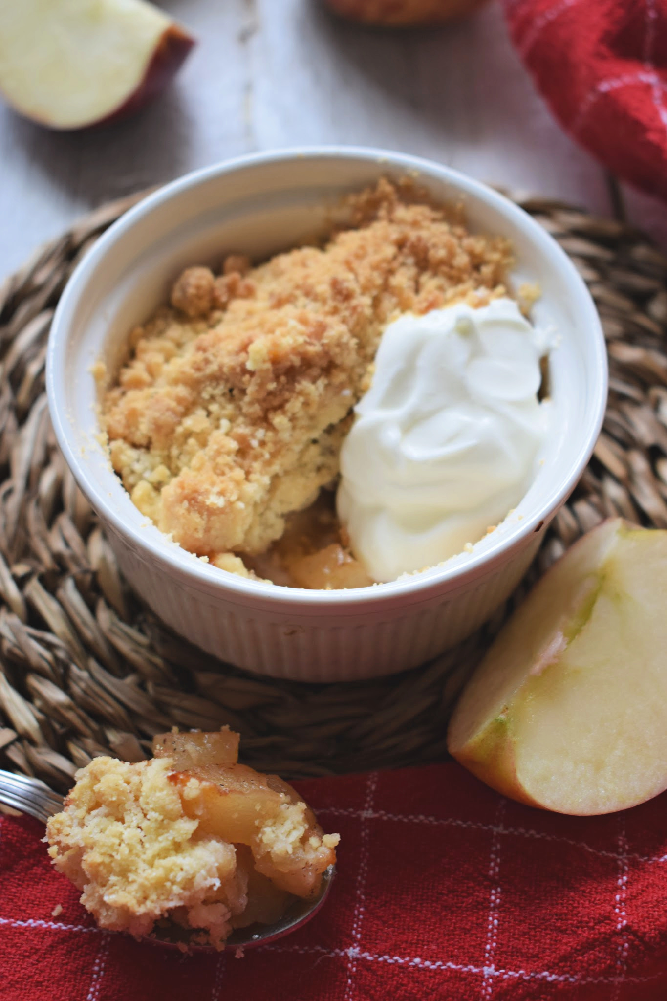 mini apple crumble in a bowl with whipped cream