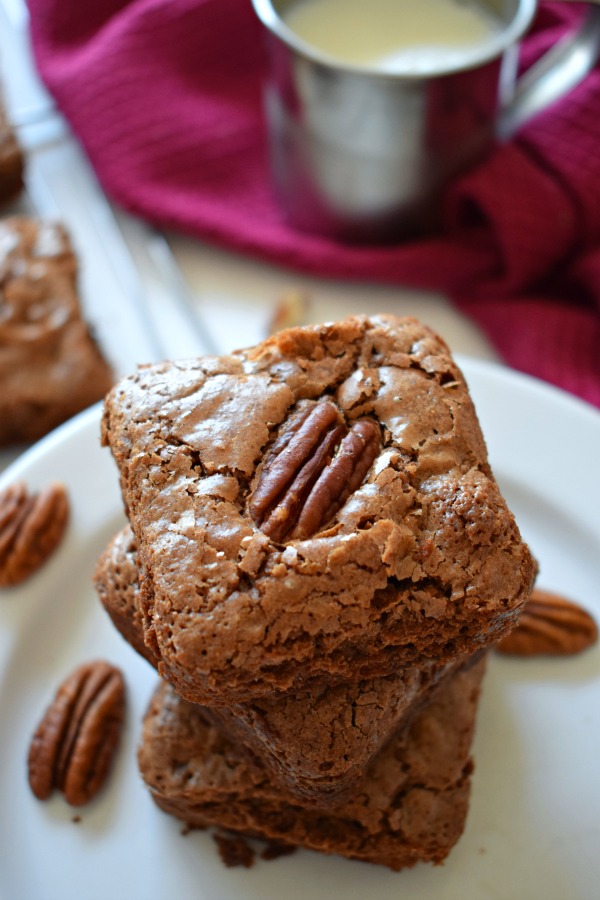 Stacked Chocolate Pecan Brownies with a napkin and cup of milk