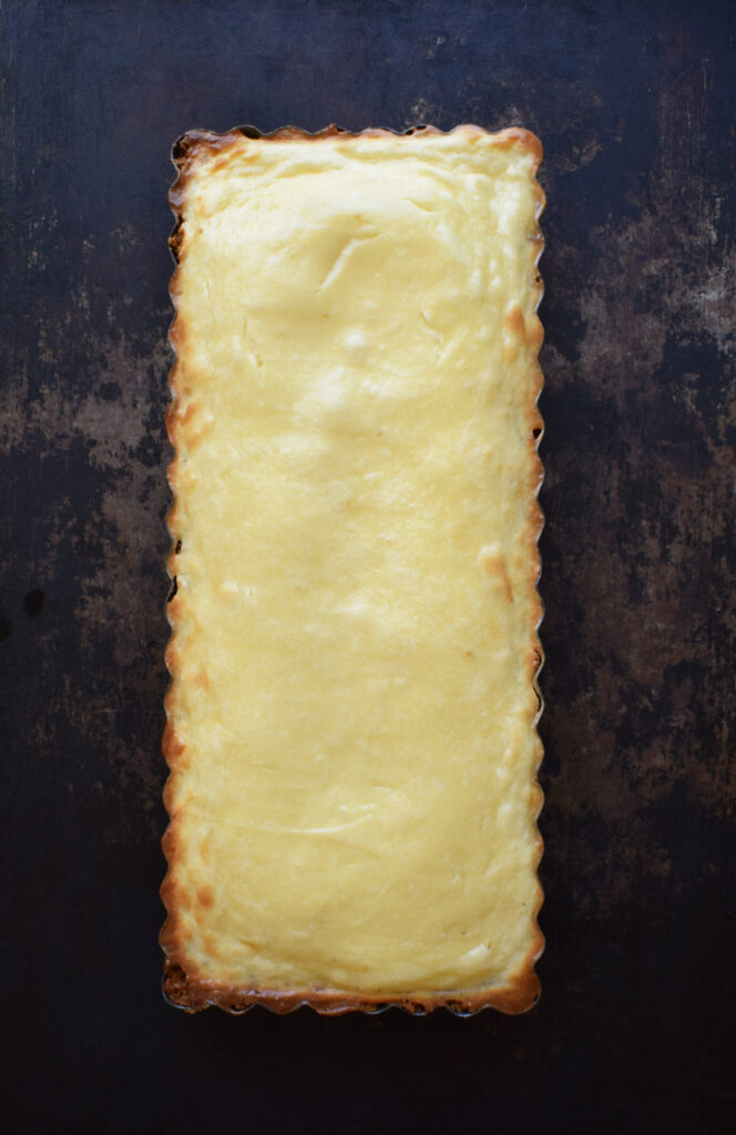 Baked cheesecake tart in a tin.