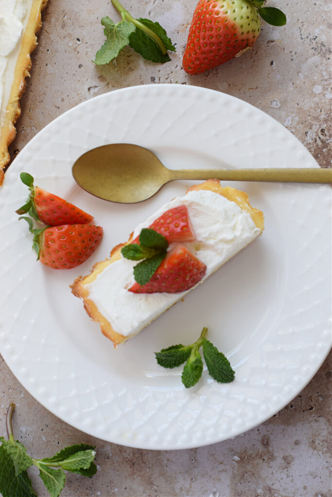 A slice of cheesecake on a white plate.