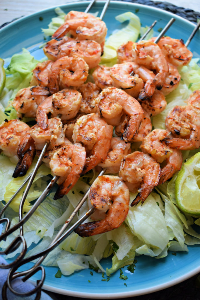 grilled shrimp with chimichurri salsa on a bed of lettuce