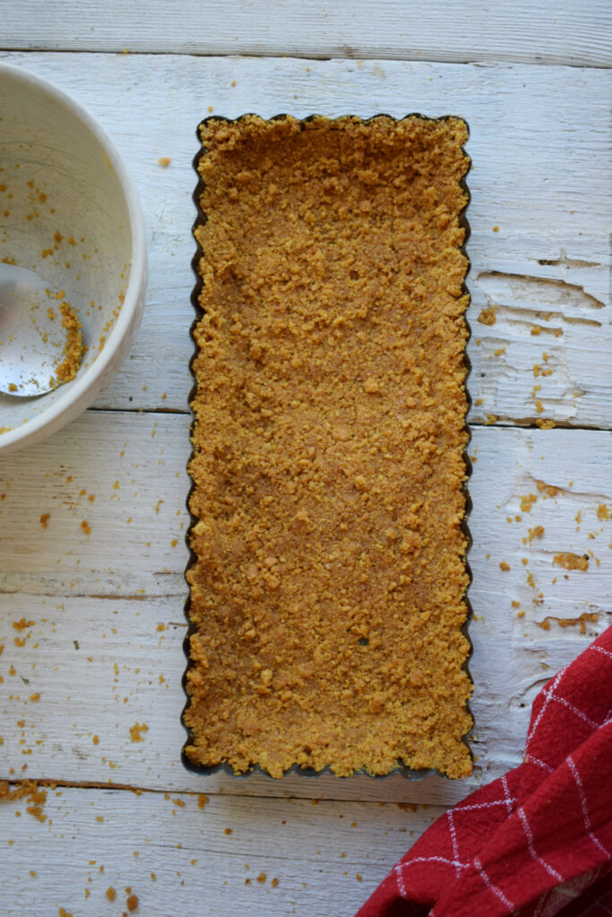 Cheesecake cookie base in a tart tin.