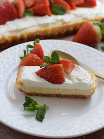 Slice of cheesecake tart on a white plate.