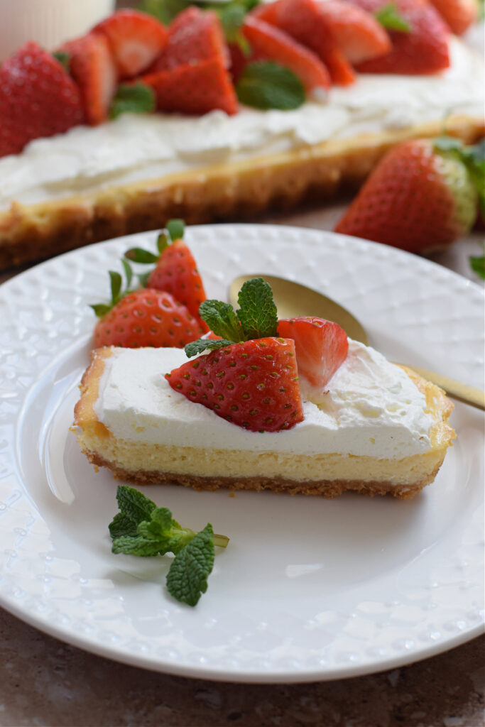 Slice of cheesecake tart on a white plate.