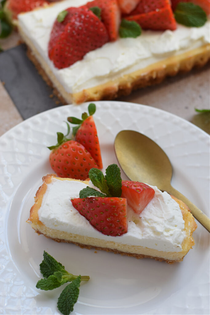 Cheesecake tart slice on a white plate.