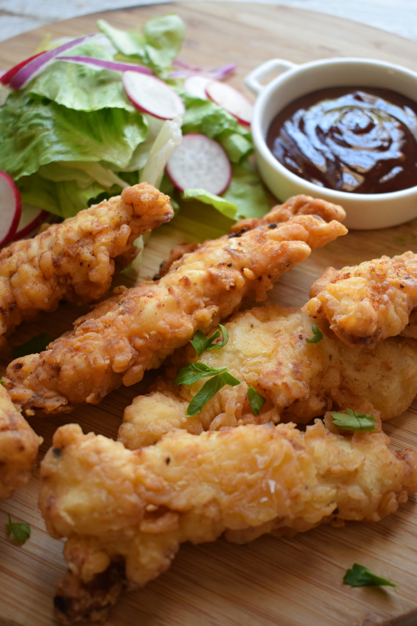 Crispy Chicken Tenders on a plate with a dipping sauce