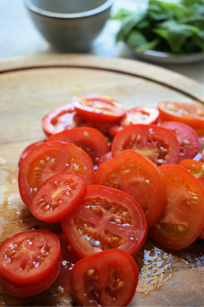 fresh cut tomatoes on a cutting board