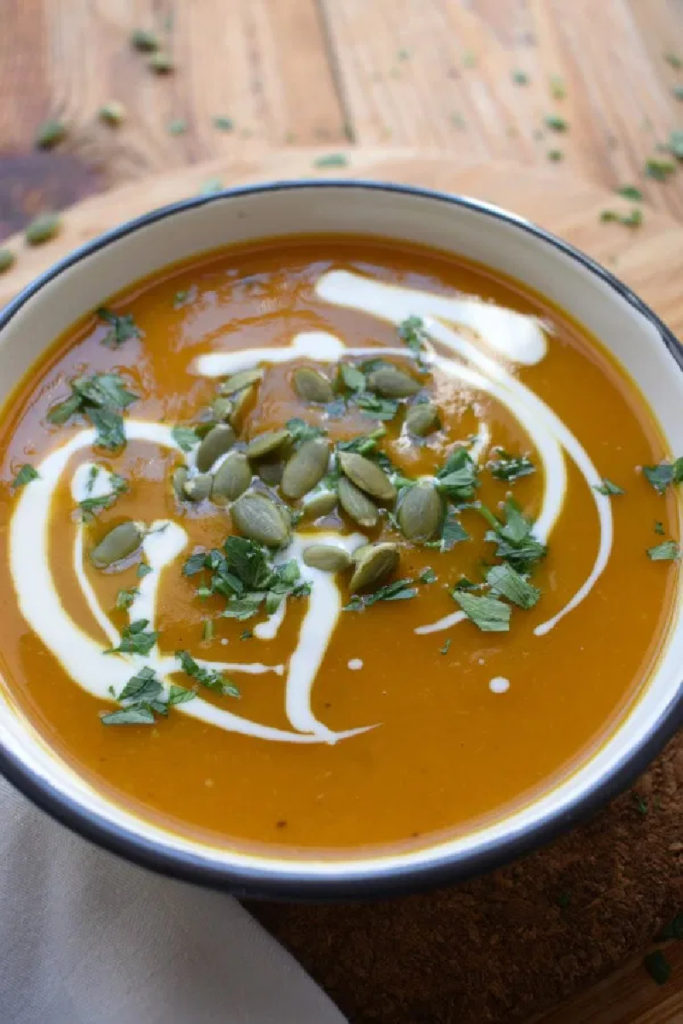 squash soup topped with seeds and parsley