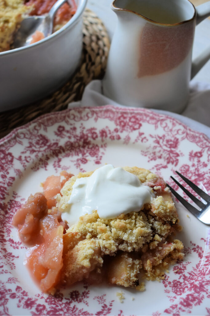 apple and strawberry crumble on a pink floral plate