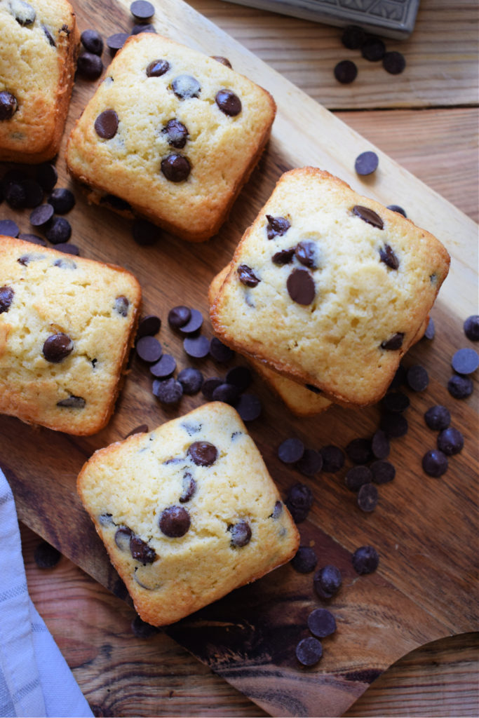 chocolate chip cake squares on a board with chocolate chips
